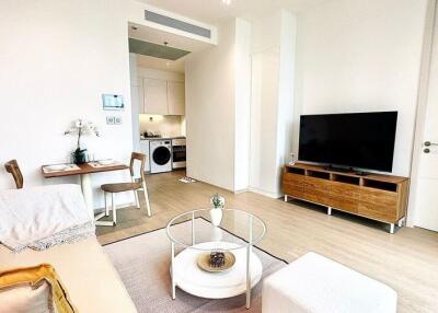 Modern living room with a view of a small dining area and kitchen