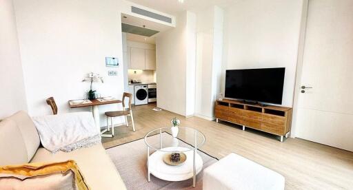 Modern living room with a view of a small dining area and kitchen