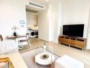 Modern living room with a small dining area and a view of the kitchen