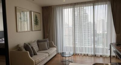 Modern living room with a large window, sofa, and coffee table