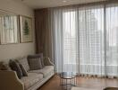 Modern living room with a large window, sofa, and coffee table