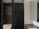 Modern bathroom with black marble surfaces and large mirror