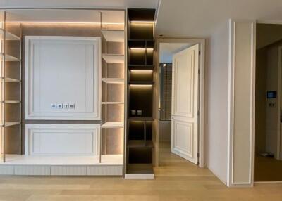 Modern living room with built-in shelving and wooden flooring