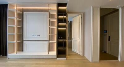 Modern living room with built-in shelving and wooden flooring