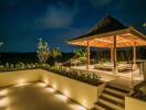 Elegant outdoor pavilion at night with seating area