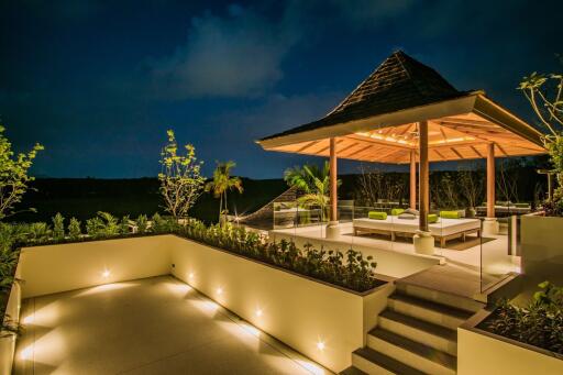 Elegant outdoor pavilion at night with seating area