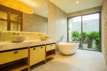 Modern bathroom with double vanity and freestanding bathtub