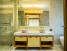 Modern bathroom with dual sinks on marble countertop and large mirrors