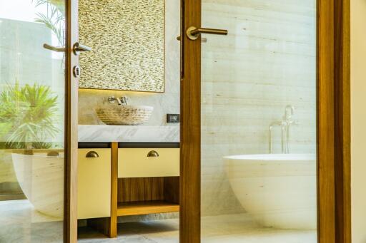 Modern bathroom with wooden accents and a freestanding bathtub