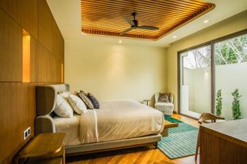 Modern bedroom with wooden ceiling accents and large window