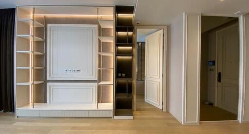 Contemporary living space with built-in wall shelving and modern lighting