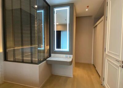 Modern bedroom with glass partition and vanity area