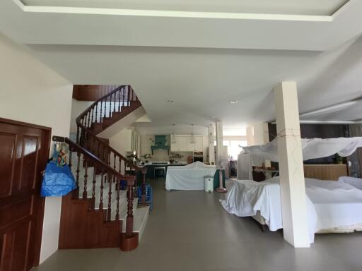Main living area with staircase, kitchen, and dining space