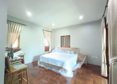 Bright spacious bedroom with double bed and two windows