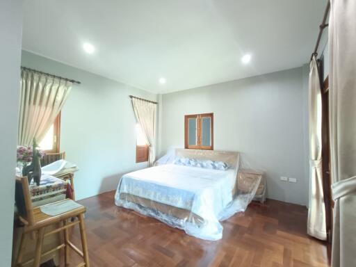 Bright spacious bedroom with double bed and two windows