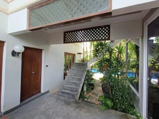 Outdoor area with stairway and tropical garden