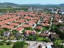 Aerial view of a residential neighborhood with numerous houses featuring red-tiled roofs