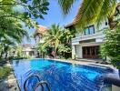 Outdoor area with a pool and lush greenery