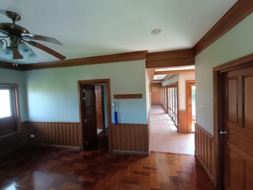 Living area with wooden flooring and ceiling fan