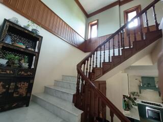 Wooden staircase with decorative cabinet