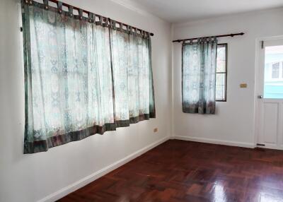 Empty bedroom with curtained windows