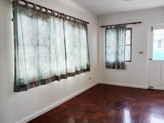 Empty bedroom with curtained windows