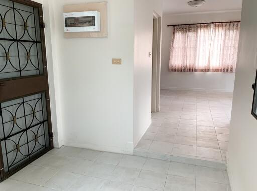 Bright hallway with gated door and windowed space