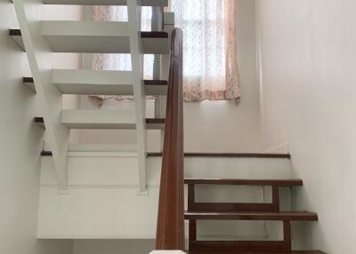 Staircase with wooden steps and handrail.