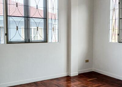 Unfurnished bedroom with wooden flooring and large windows