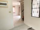 Entrance hallway leading to living area with visible staircase