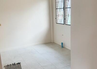 Empty room with tiled floor and two windows