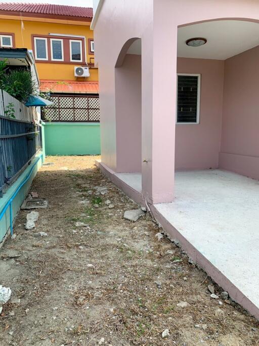 Outdoor view of side porch and adjacent garden area