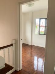 Empty bedroom with wooden floor and window