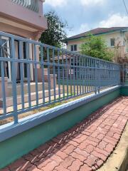 House exterior with gate and garden