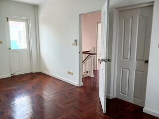 Room with wooden flooring and white doors
