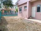 Backyard area with partial view of the building and neighboring houses