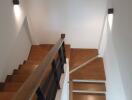 Modern staircase with wooden steps and sleek railing