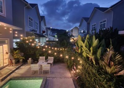 Evening view of a cozy patio with a pool