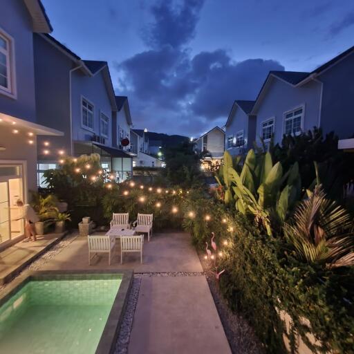 Evening view of a cozy patio with a pool