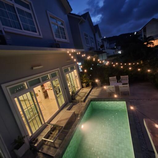 House exterior with pool at dusk