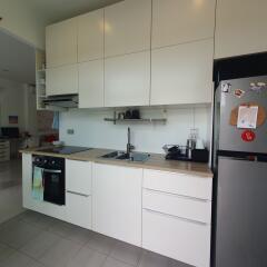 Modern kitchen with white cabinets and stainless steel appliances