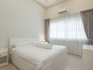 Modern bedroom with white decor, bed, curtains and air conditioning