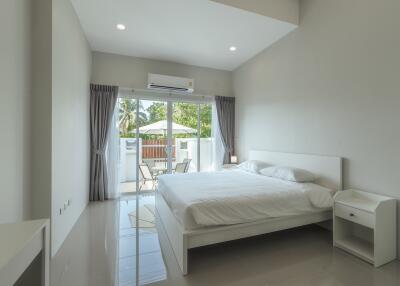 Spacious and modern bedroom with large window and outdoor view