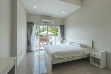 Spacious and modern bedroom with large window and outdoor view