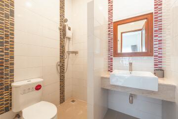 Modern bathroom with shower, toilet, and sink