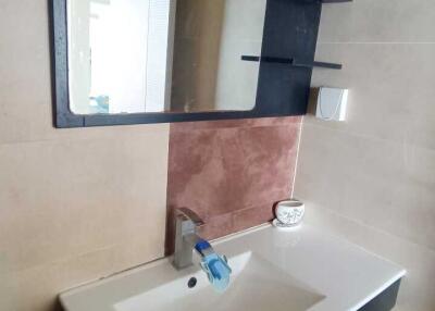 Modern bathroom sink with large mirror and shelving