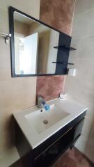 Modern bathroom sink with large mirror and shelving