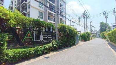 Front entrance of a residential building with well-maintained greenery