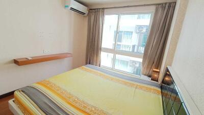 Cozy bedroom with large window and air conditioner