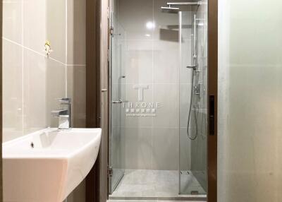 Modern bathroom with a glass-enclosed shower and sink